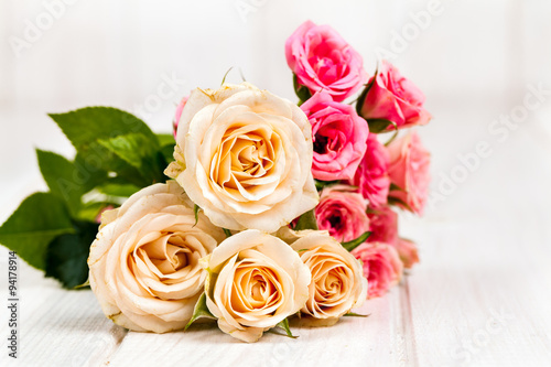 roses on white wooden planks background. flowers