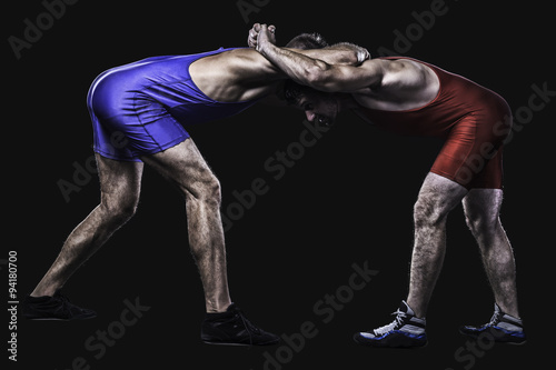 Two wrestlers holding each other in stand isolated