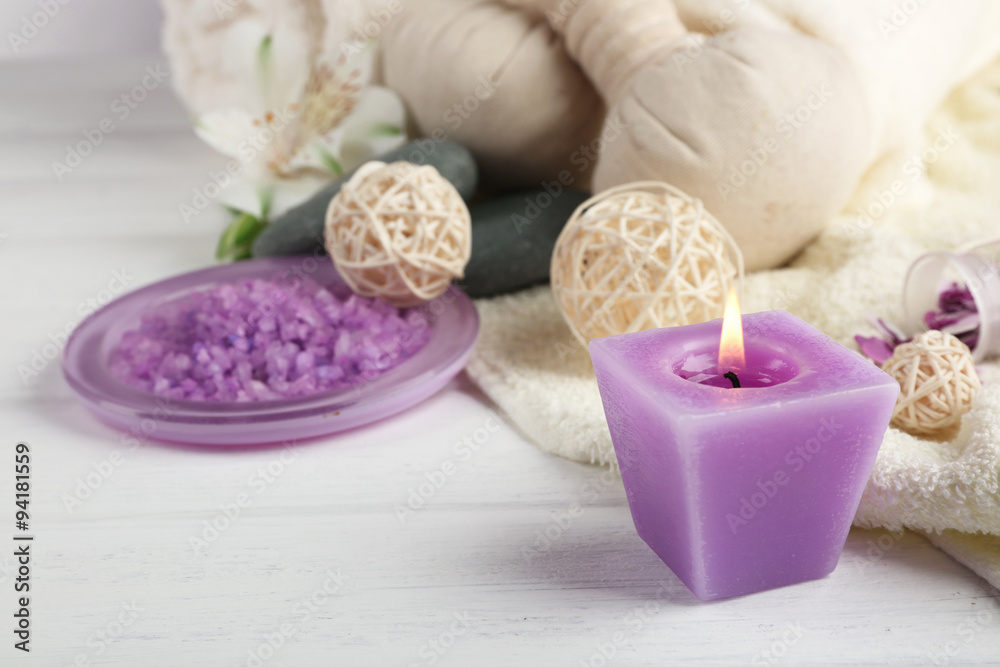 Spa treatment and flowers on wooden table, on light background Spa treatment and flowers on wooden table, on light background