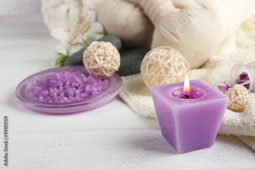 Spa treatment and flowers on wooden table  on light background