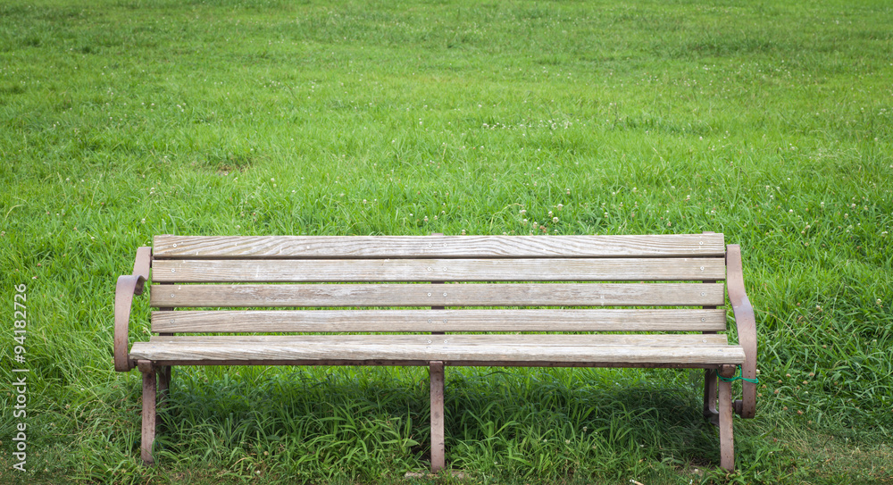 Wood bench at green park in summer season Wood bench at green park in summer season