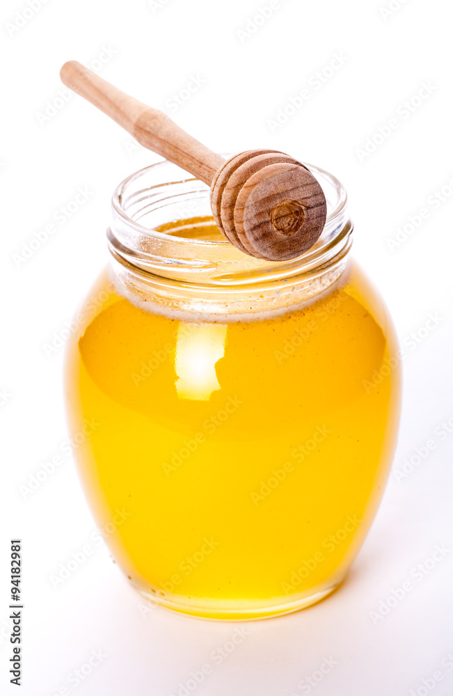 Glass jar full of honey on a white background. food, medicine Glass jar full of honey on a white background. food, medicine