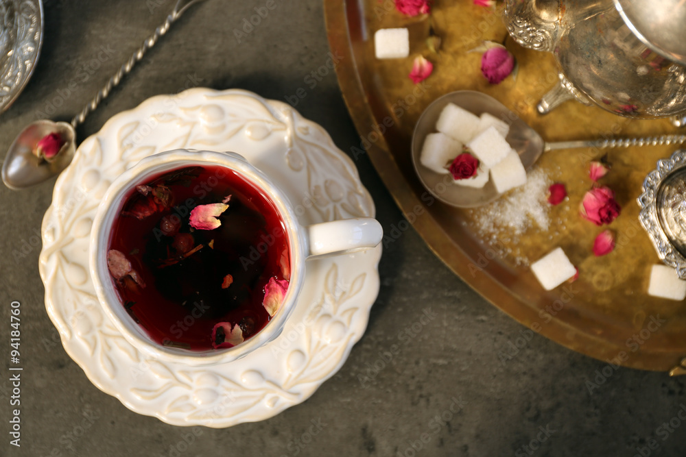 Cup of rose tea with sugar on wooden table Cup of rose tea with sugar on wooden table