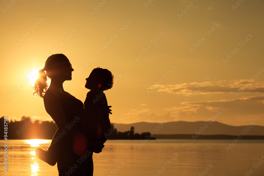 Mother and son playing on the coast of lake