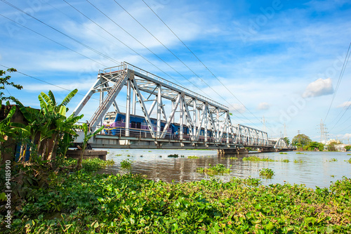 Train crossing the Binh Loi bridge in Hochiminh city, Vietnam