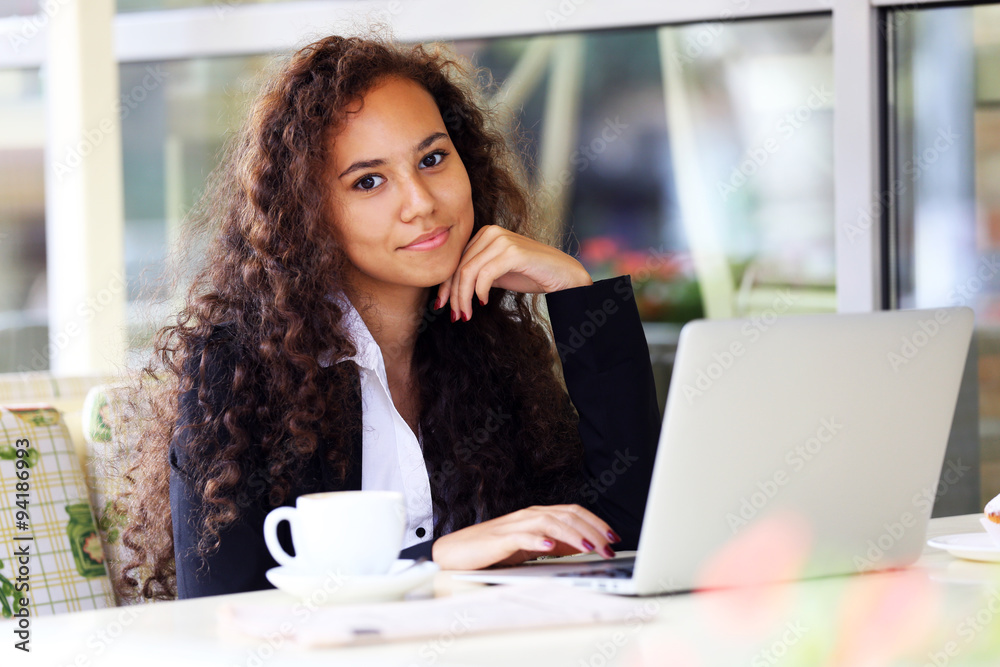 Young pretty business woman with laptop in the restaurant Young pretty business woman with laptop in the restaurant