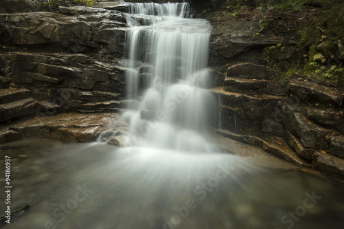 Silky water of Stairs Falls in Franconia Notch  New Hampshire.