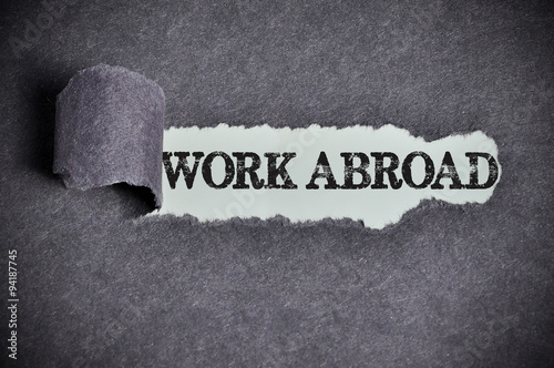 work abroad word under torn black sugar paper