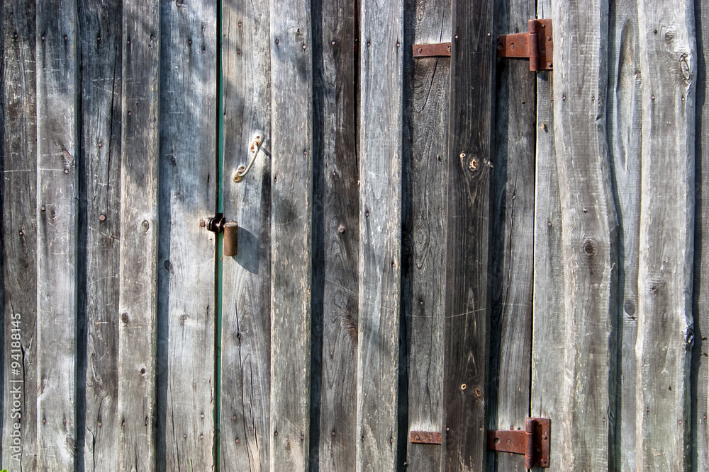 Grunge wooden wall with door, door butt and check-lock. Background. Grunge wooden wall with door, door butt and check-lock. Background.