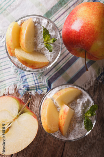 Chia seed pudding and apples in a glass closeup. vertical top view