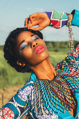 Beautiful black girl model in a blue dress and jewelry