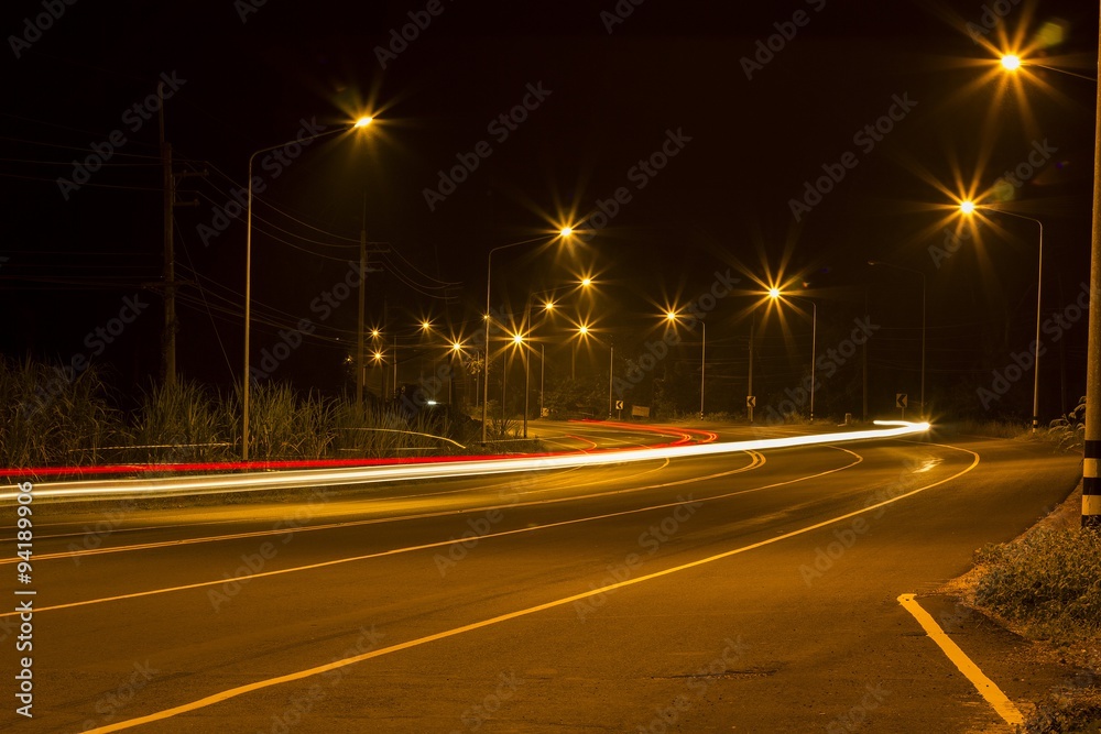 Night Road at suburban with the light trails car 