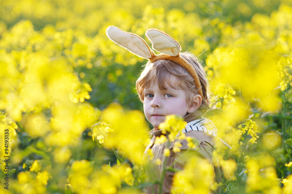 Funny boy of 3 years with Easter bunny ears, celebrating Easter Funny boy of 3 years with Easter bunny ears, celebrating Easter