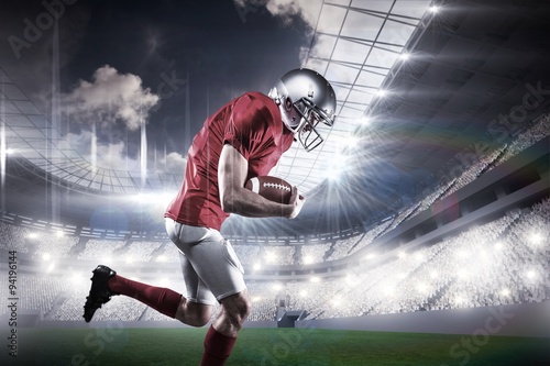 American football player holding ball while running © vectorfusionart