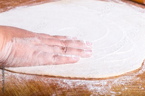 Womens hands in a process of preparing of dough for lagman