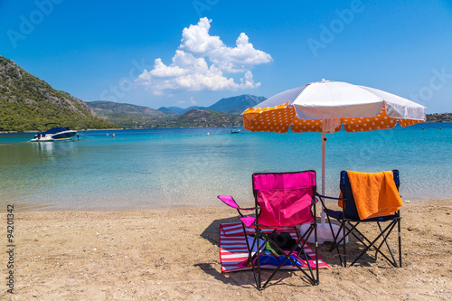 Umbrella and sundecks on beach, Greece photo