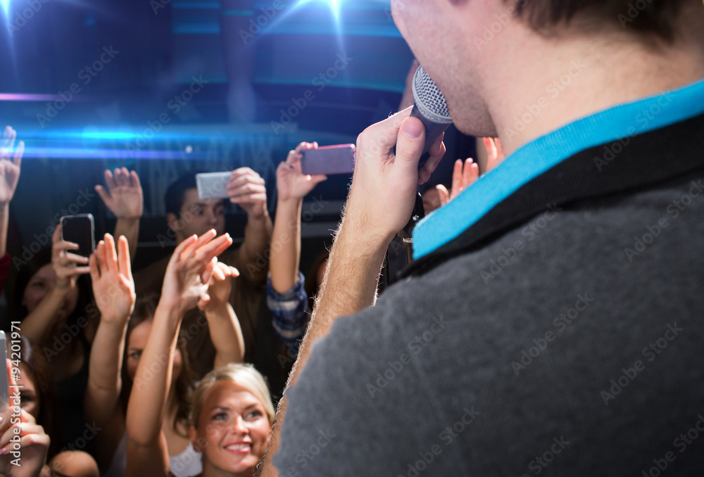 Obraz premium close up of happy people at concert in night club