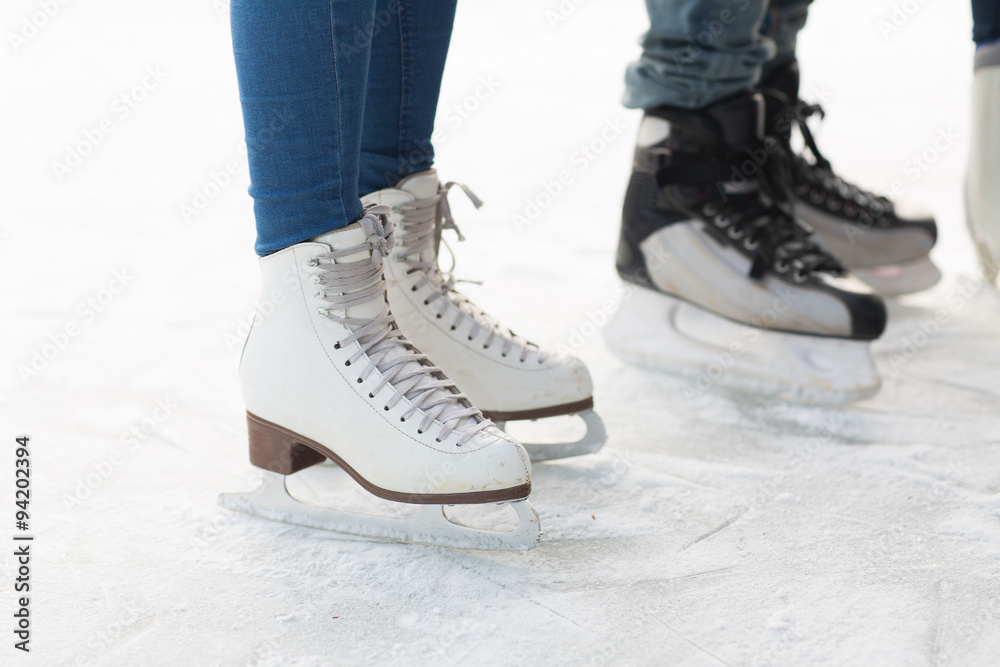 close up of legs in skates on skating rink close up of legs in skates on skating rink