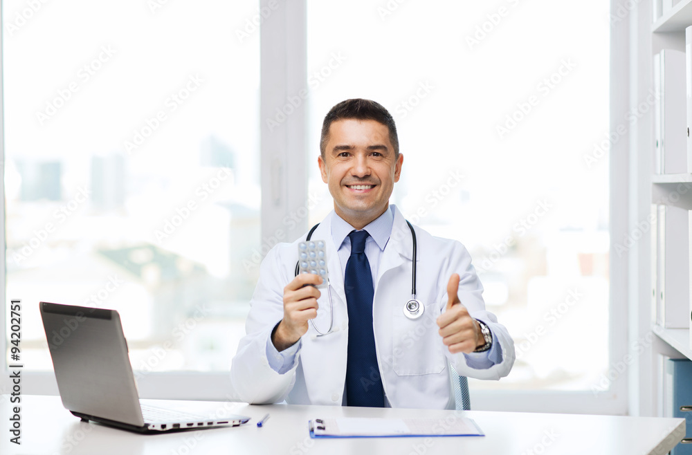 smiling doctor with tablets showing thumbs up