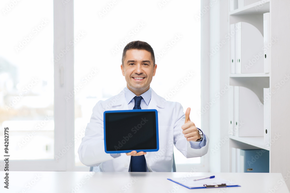 smiling doctor showing tablet pc and thumbs up
