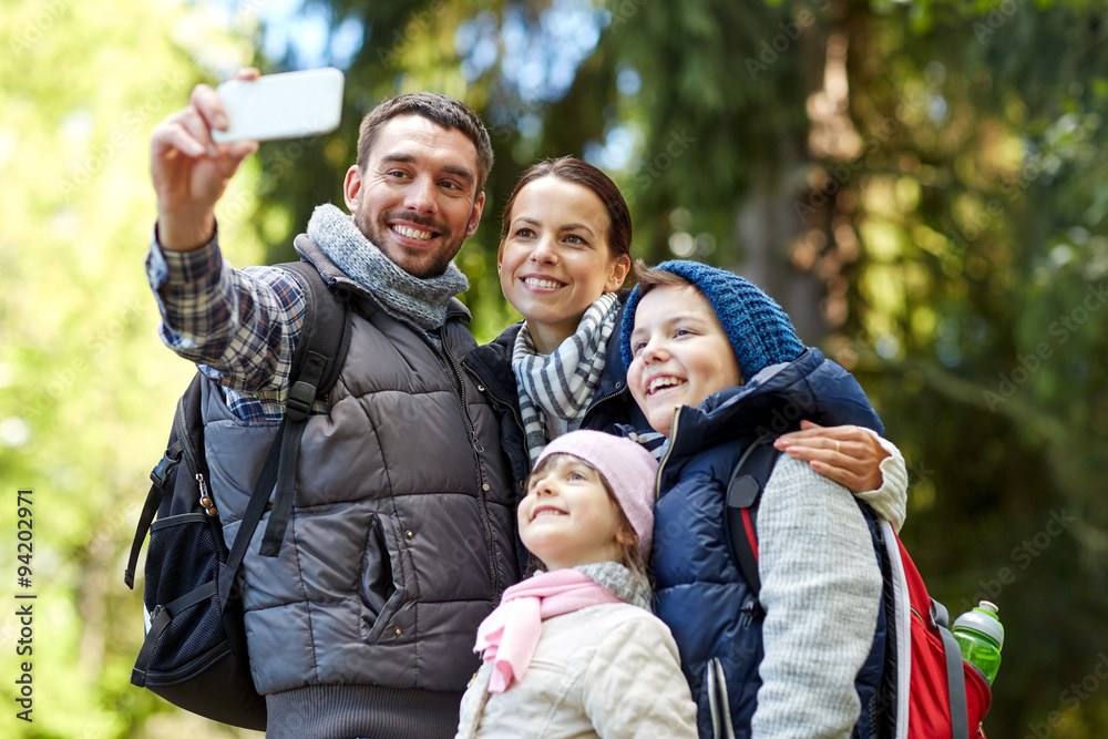 family taking selfie with smartphone in woods family taking selfie with smartphone in woods