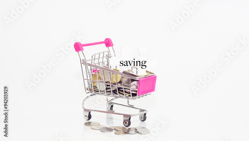 Saving Concept.Puzzle With Word Saving And Shopping cart with co photo