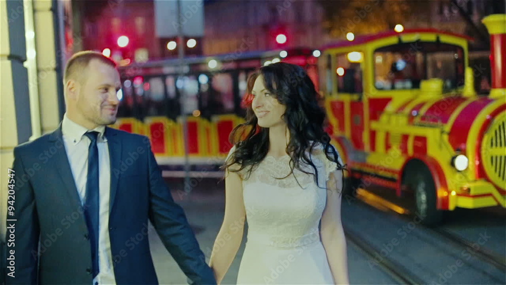 Just married couple walking night city Just married couple walking night city