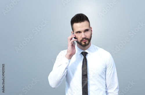 Businessman using cellphone, handsome businessman on creative ba