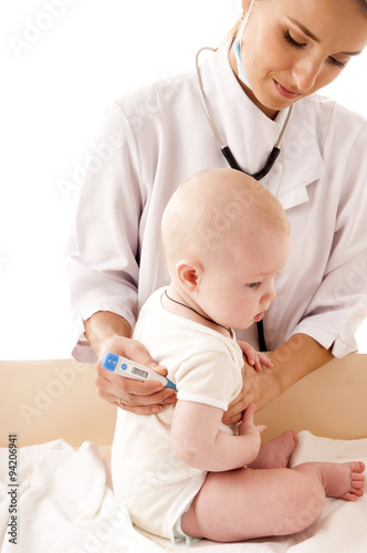 Nurse measures the temperature of a baby, isolated on white back
