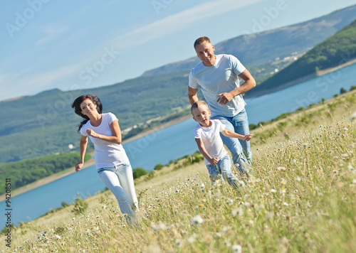 Happy family in a camomile field 
