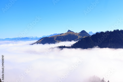 Panoramablick vom bayerischen Gebirge aus in das Kaisergebirge nach Tirol in Österreich, oberhalb einer Wand aus Nebel