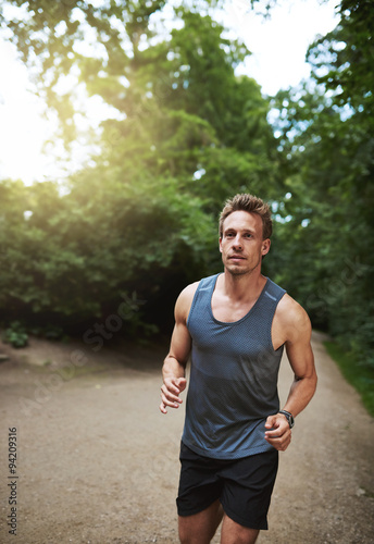 Jogger running through a wooded park