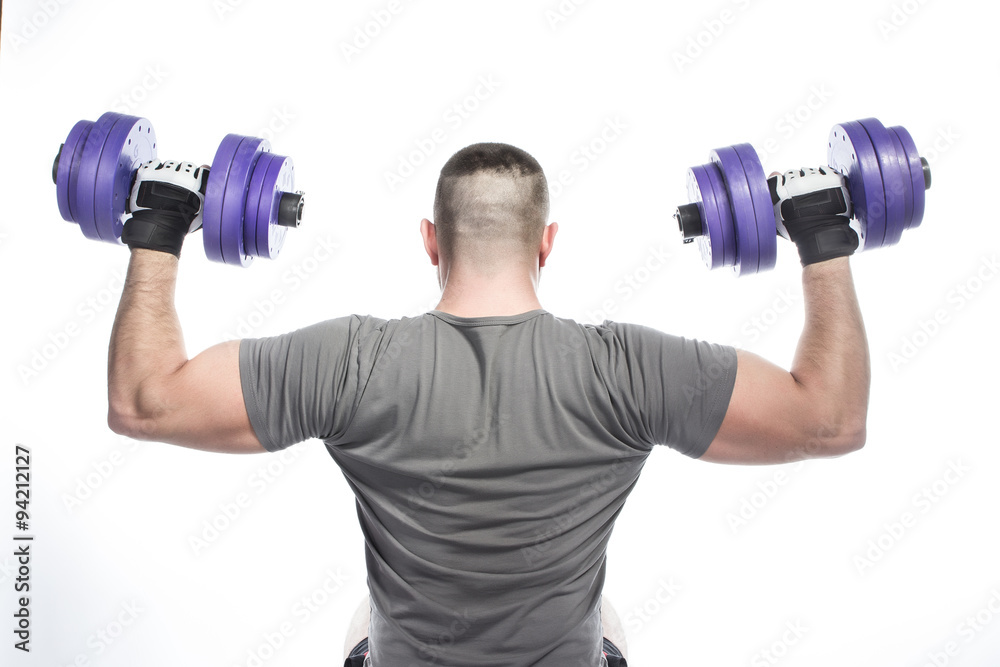 Back view of muscular man in gloves holding dumbbells under head Back view of muscular man in gloves holding dumbbells under head