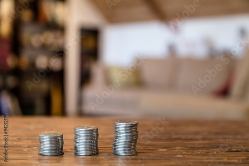 Close-up the stacks of coins on a wooden table