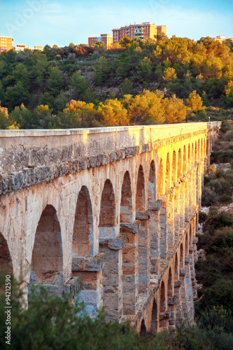  Roman aqueduct Devil's Bridge (Pont del Diable, Les Ferreres Aqueduct) on the Sunset.  Tarragona in Catalonia, Spain.