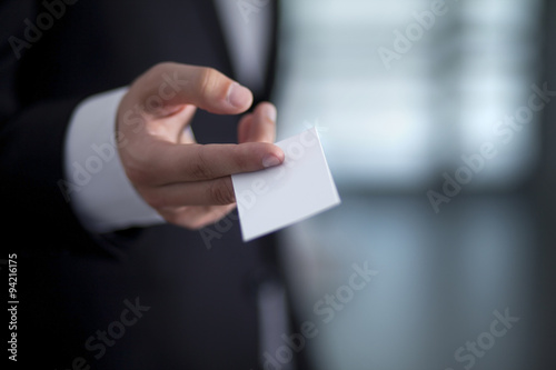 Businessman giving to someone blank business card