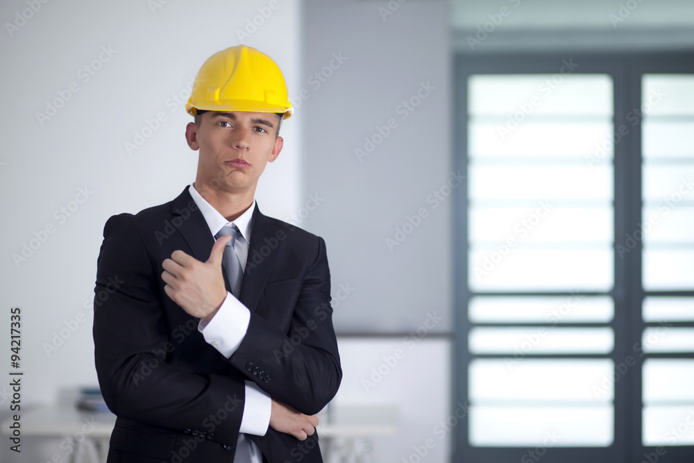 Successful businessman with yellow helmet poses and hand gesturi Successful businessman with yellow helmet poses and hand gesturi