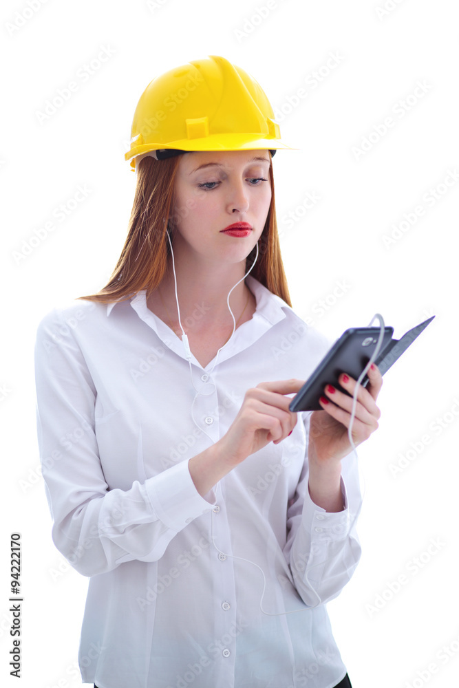 Young beautiful female with yellow helmet using a cellphone Young beautiful female with yellow helmet using a cellphone
