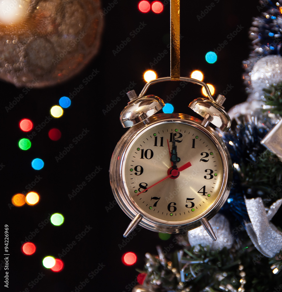 clock ,a decorated Christmas tree on a black background with lig clock ,a decorated Christmas tree on a black background with lig