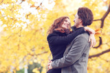 Couple hugging in autumn park