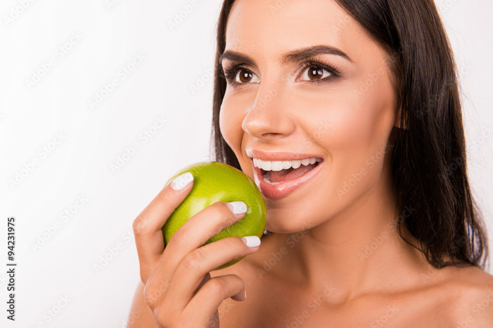 Beautiful healthy toothy smile. Girl smiling with green apple Beautiful healthy toothy smile. Girl smiling with green apple
