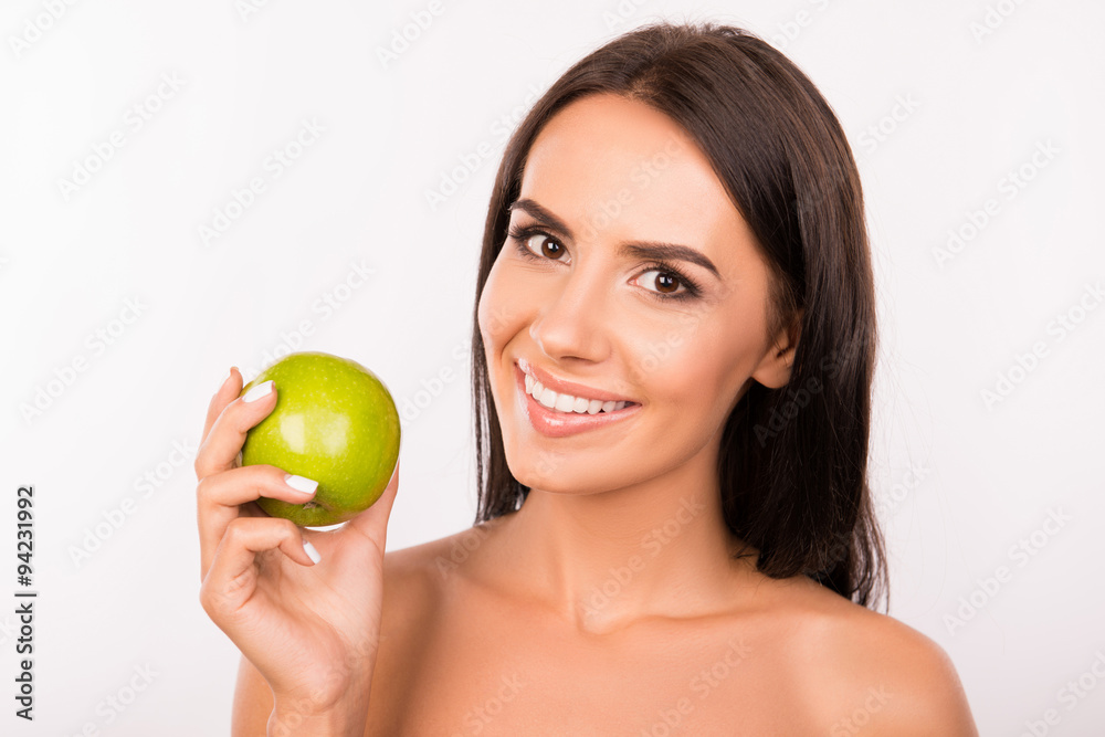 Beautiful healthy toothy smile. Girl smiling with green apple Beautiful healthy toothy smile. Girl smiling with green apple