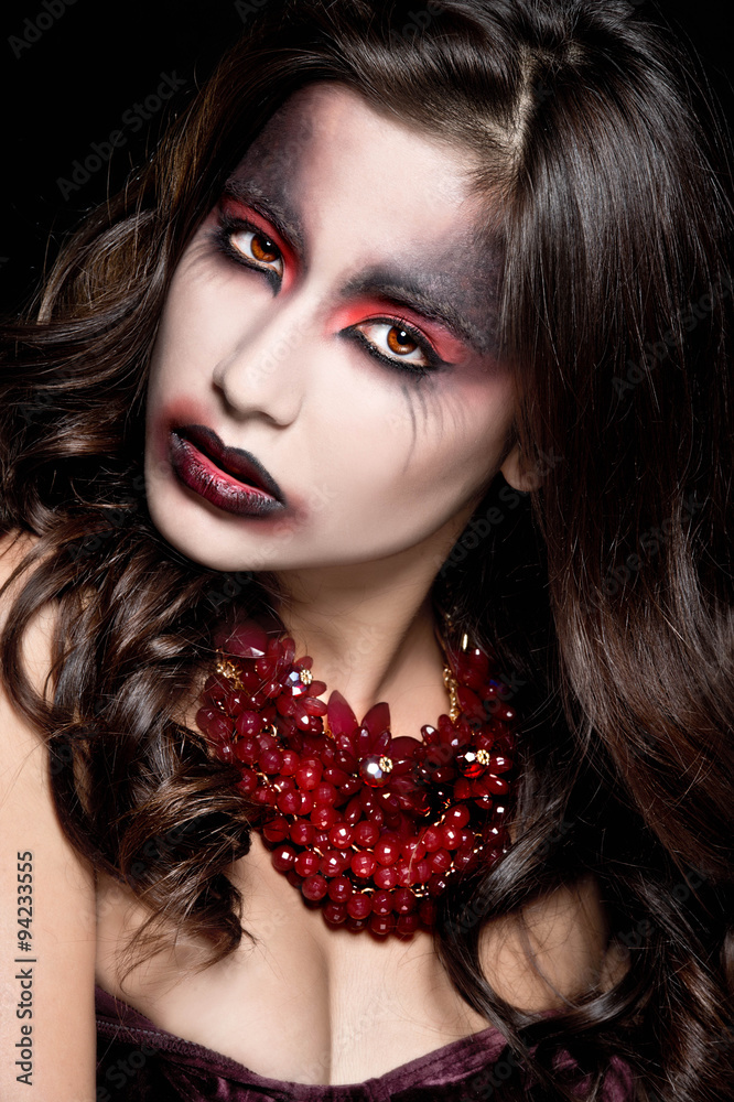 Fototapeta premium Portrait of a pale gothic vampire woman. Halloween Make up. 