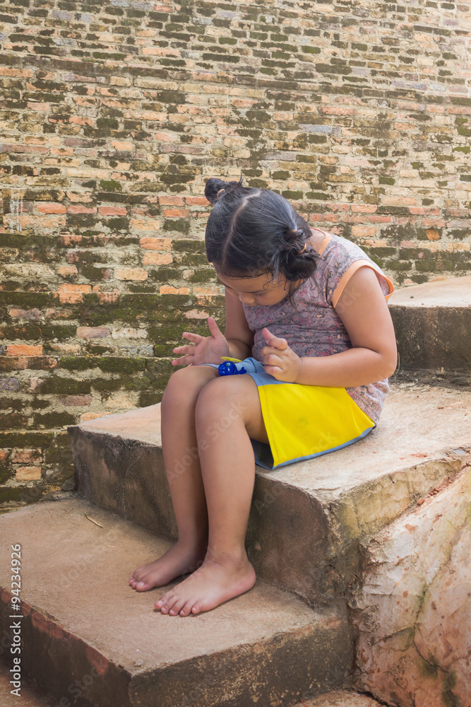 Fototapeta premium Little lovely Asia girl kid playing alone