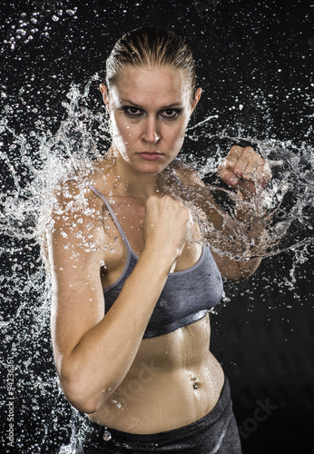 Photography Athletic Woman in Combat Pose in Water Splashes