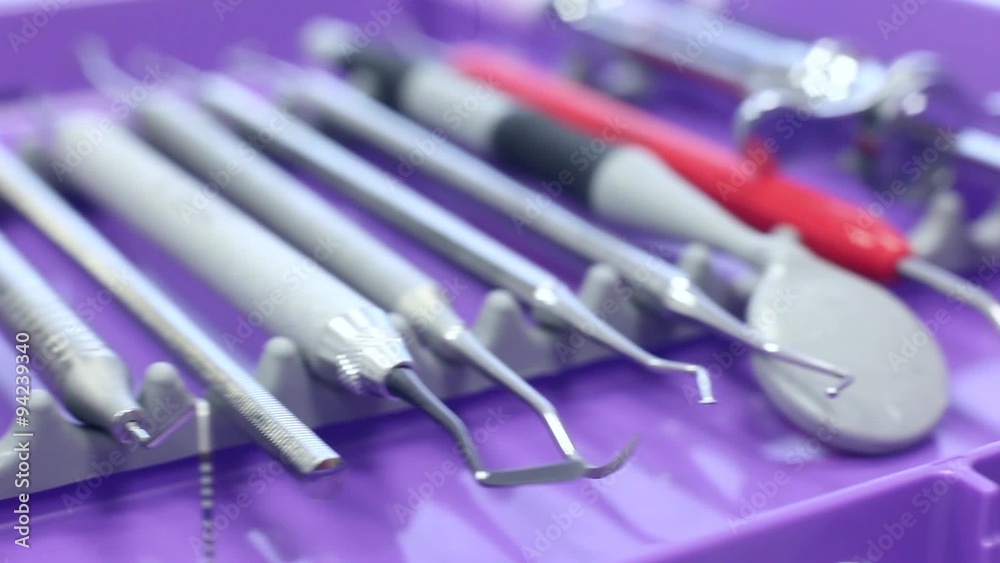 Different dental instruments on a purple tray / camera moving right / close-up Different dental instruments on a purple tray / camera moving right / close-up
