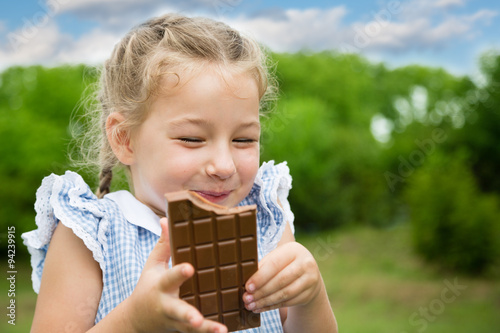 Joyful girl eating chocolate