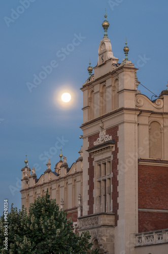 Renaissance details on the Cloth Hall (Sukiennice) building on the main market square in Krakow, Poland, with full moon #94240134