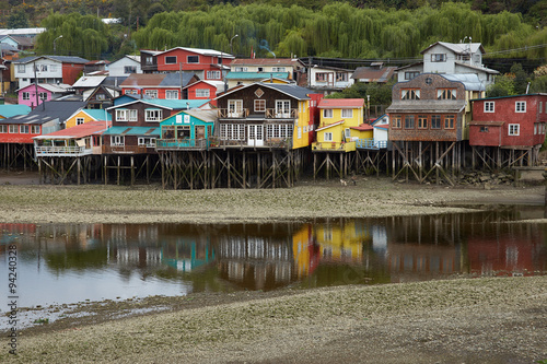 Houses built on stilts, known locally as Palafitos, lining the waters edge in Castro, capital of the Island of Chiloe.