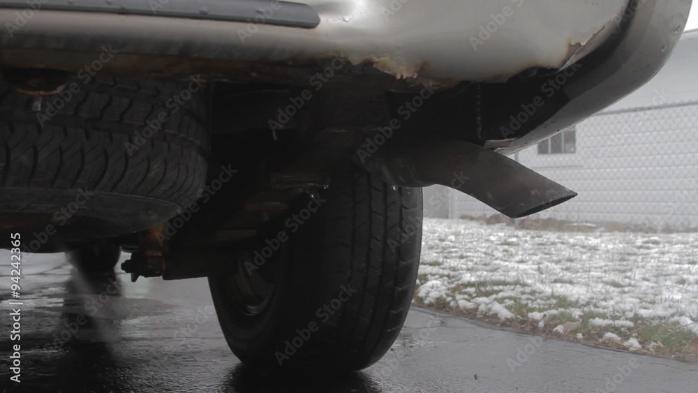 Dolly Vehicle Exhaust Various. 3 shots. medium shot of the rear of a SUV during winter idling. a dolly right macro shot of the exhaust pipe
